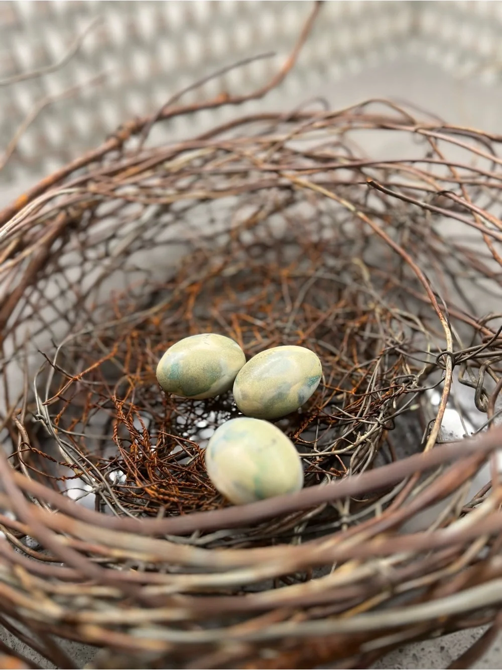 Metal rustic twig nest containing three artificial eggs decorative art